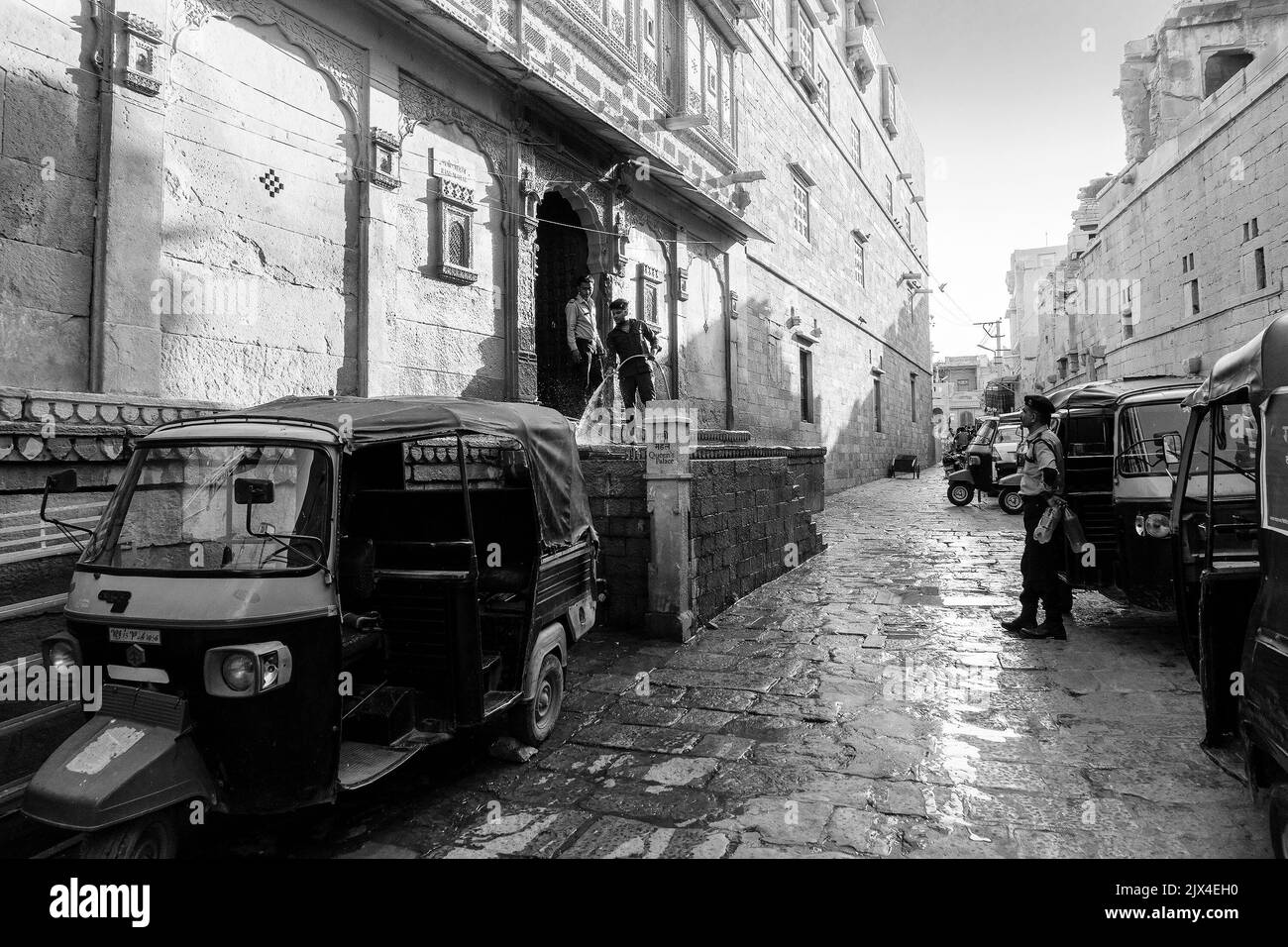 Jaisalmer, Rajasthan,India - October 13, 2019 : Indian man washing his auto with pipe water in the morning inside Jaisalmer Fort or Golden Fort. Stock Photo