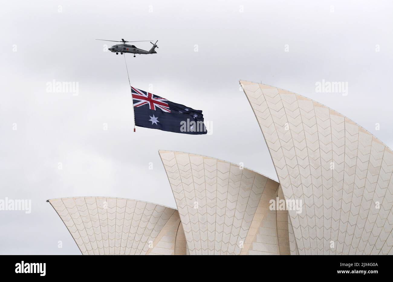 The Australian flag is flown over the Sydney Opera house by a helicopter during Australia Day celebrations in Sydney, Thursday, Jan. 26, 2017. (AAP Image/Brendan Esposito) Stock Photo