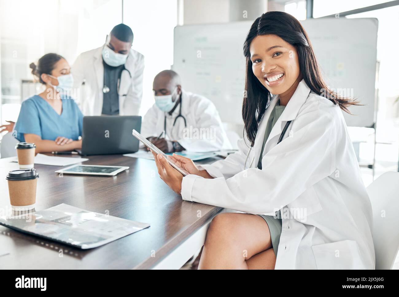Healthcare, diversity and black woman doctor with tablet at meeting