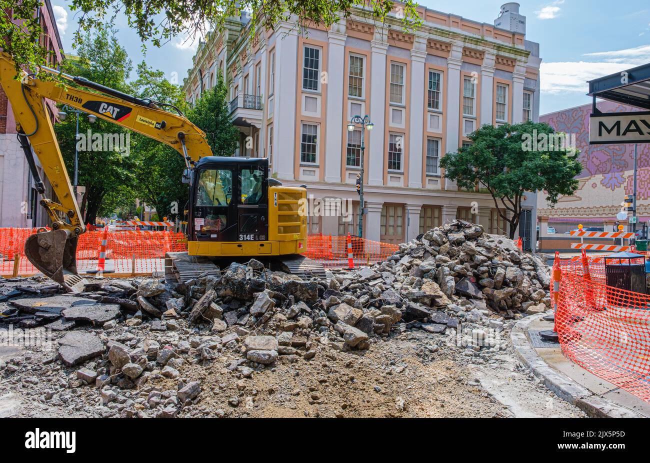 NEW ORLEANS, LA, USA -SEPTEMBER 9, 2020: Caterpillar excavator breaks up the road surface on Lafayette Street in downtown New Orleans Stock Photo