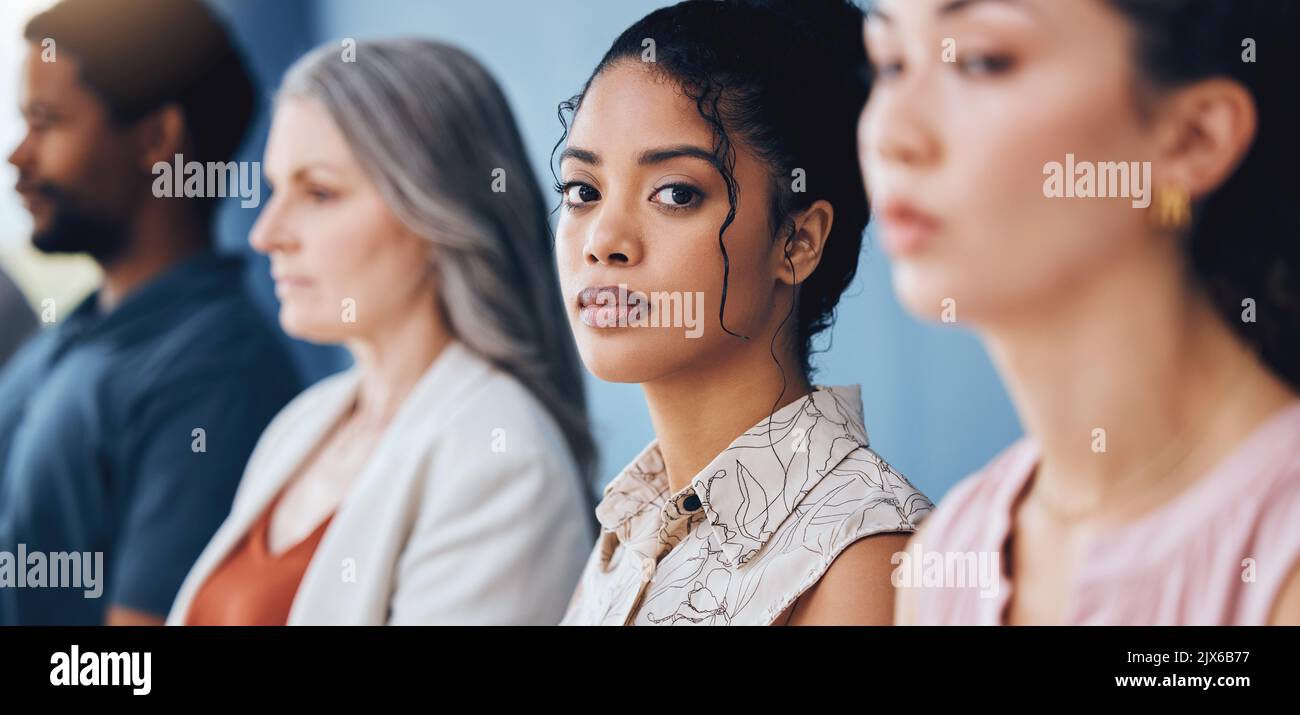 Training, learning and education with a business woman looking serious and sitting in a conference or workshop for coaching. Portrait of a female Stock Photo