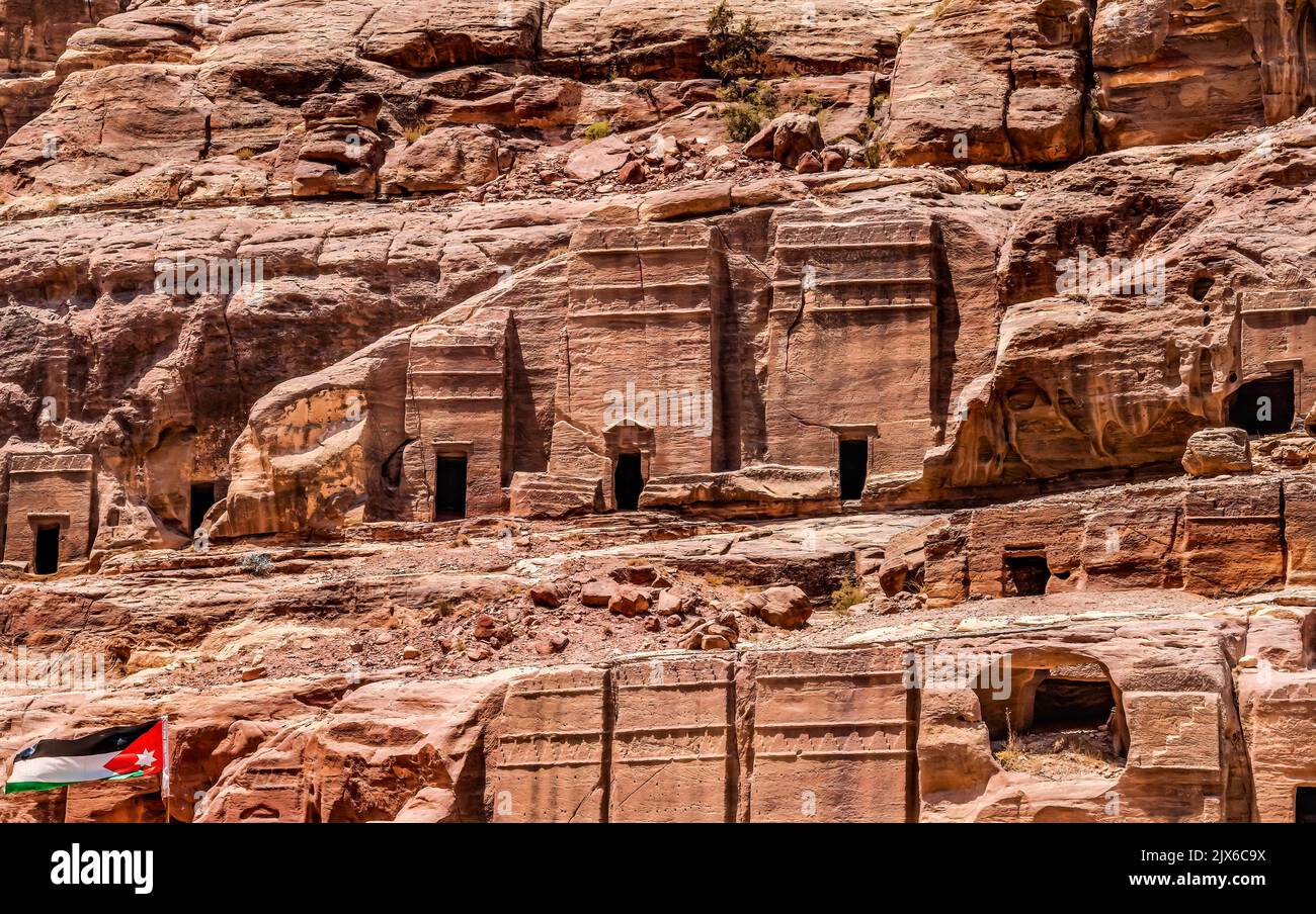 Rock Tombs Jordan Flag Morning Street of Facades Petra Jordan Built by Nabataens in 200 BC to 400 AD Canyon walls change Rose Red afternoon when sun g Stock Photo
