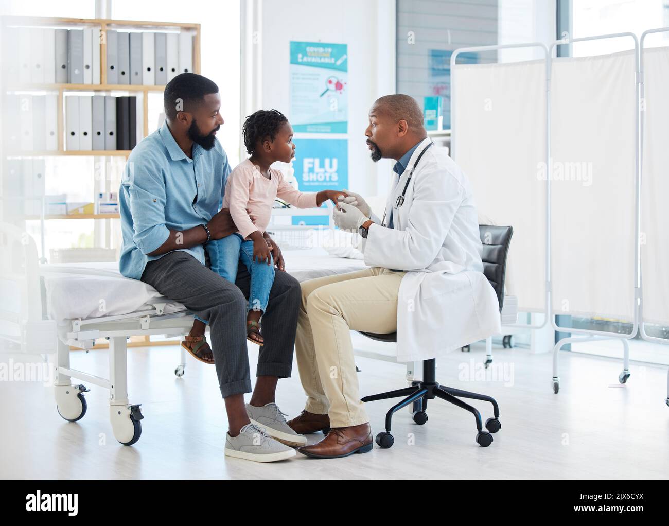 Black doctor, medicine and medical worker consulting with baby, father and child patient for covid, allergies or hospital. Nurse, trust and support Stock Photo