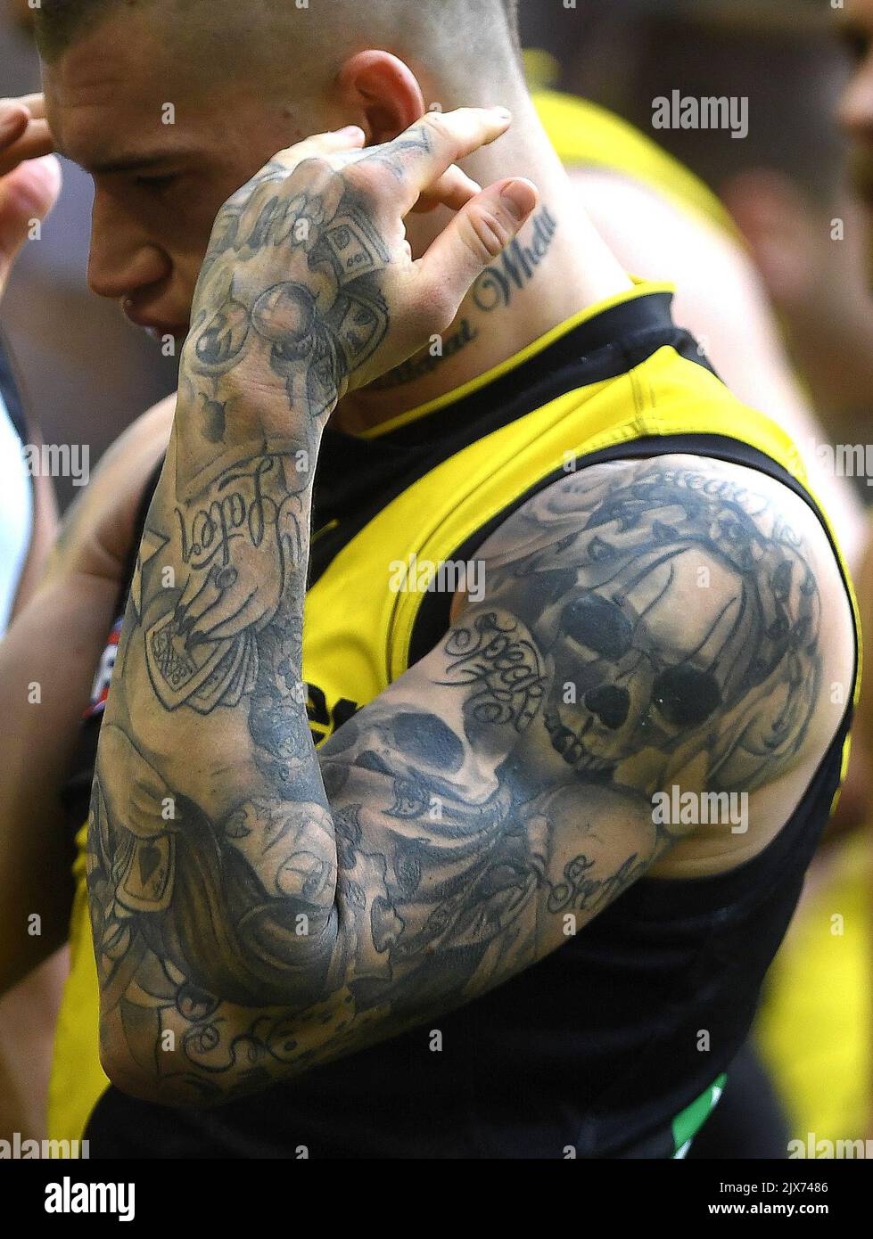 Tattoos are seen on the arms of Dustin Martin of the Tigers after the