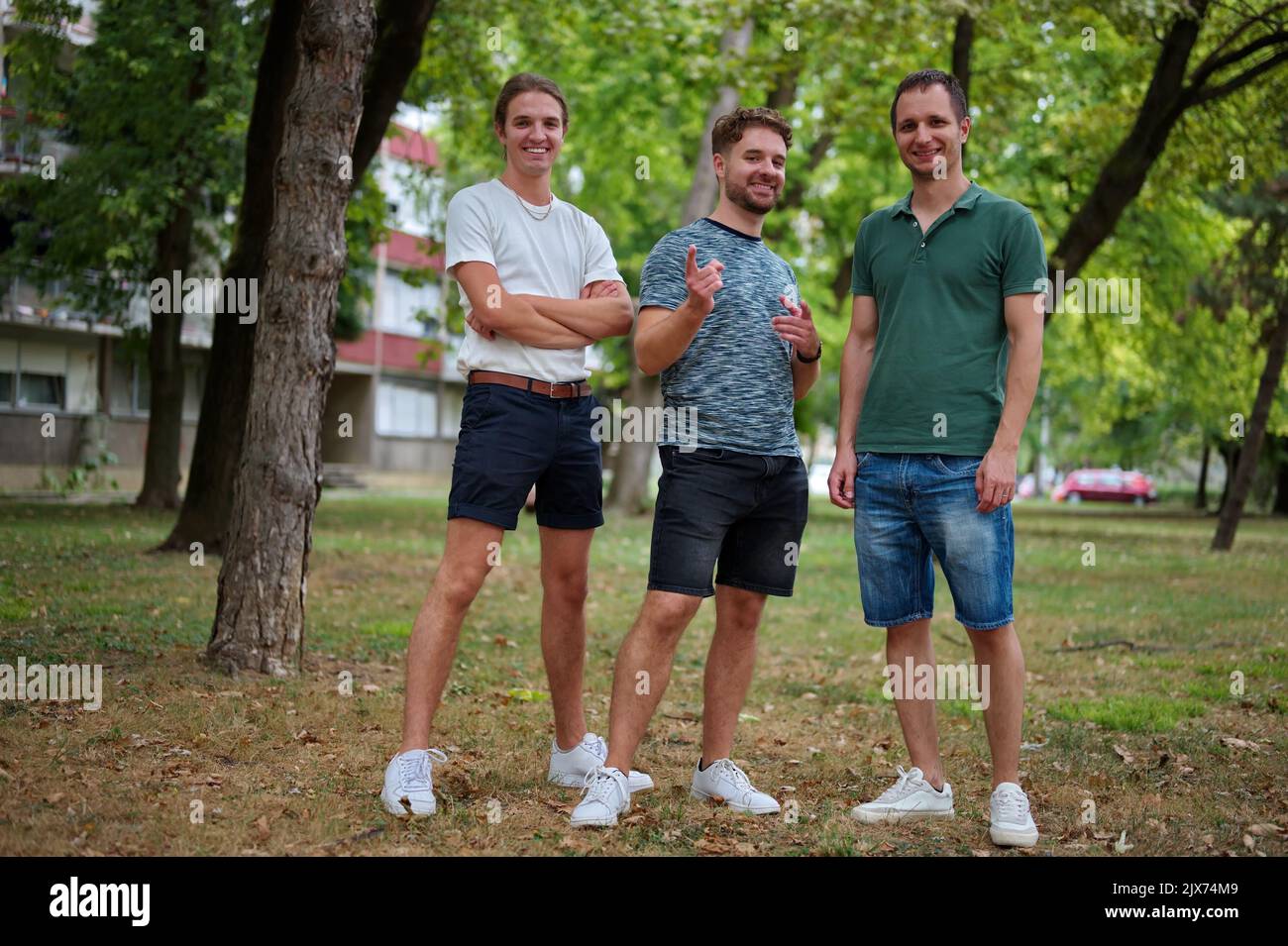 Three handsome young men having fun in a park Stock Photo