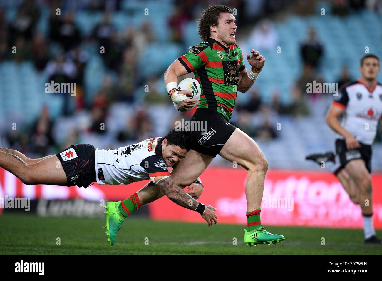 Angus Crichton of the Rabbitohs is tackled by Issac Luke of the ...