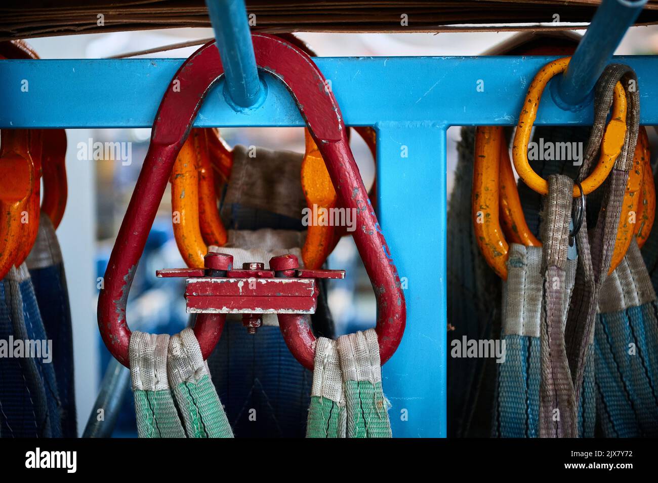 Rigging equipment with strops hangs on rack in warehouse Stock Photo