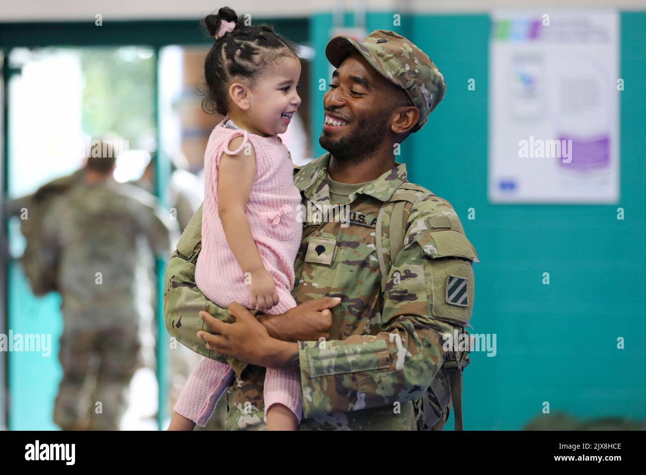 Fort Stewart, Georgia, USA. 30th Aug, 2022. U.S. Army Spc. Joshua Milton, a motor transport operator assigned to the 1st Armored Brigade Combat Team, 3rd Infantry Division, holds his dAugusthter, Malaya, after a redeployment ceremony at Fort Stewart, Georgia, August. 29, 2022. The ceremony was held at Newman Gym to mark the redeployment of the brigade's Soldiers after a six-month deployment to Grafenwoehr Training Area, Germany. Credit: U.S. Army/ZUMA Press Wire Service/ZUMAPRESS.com/Alamy Live News Stock Photo