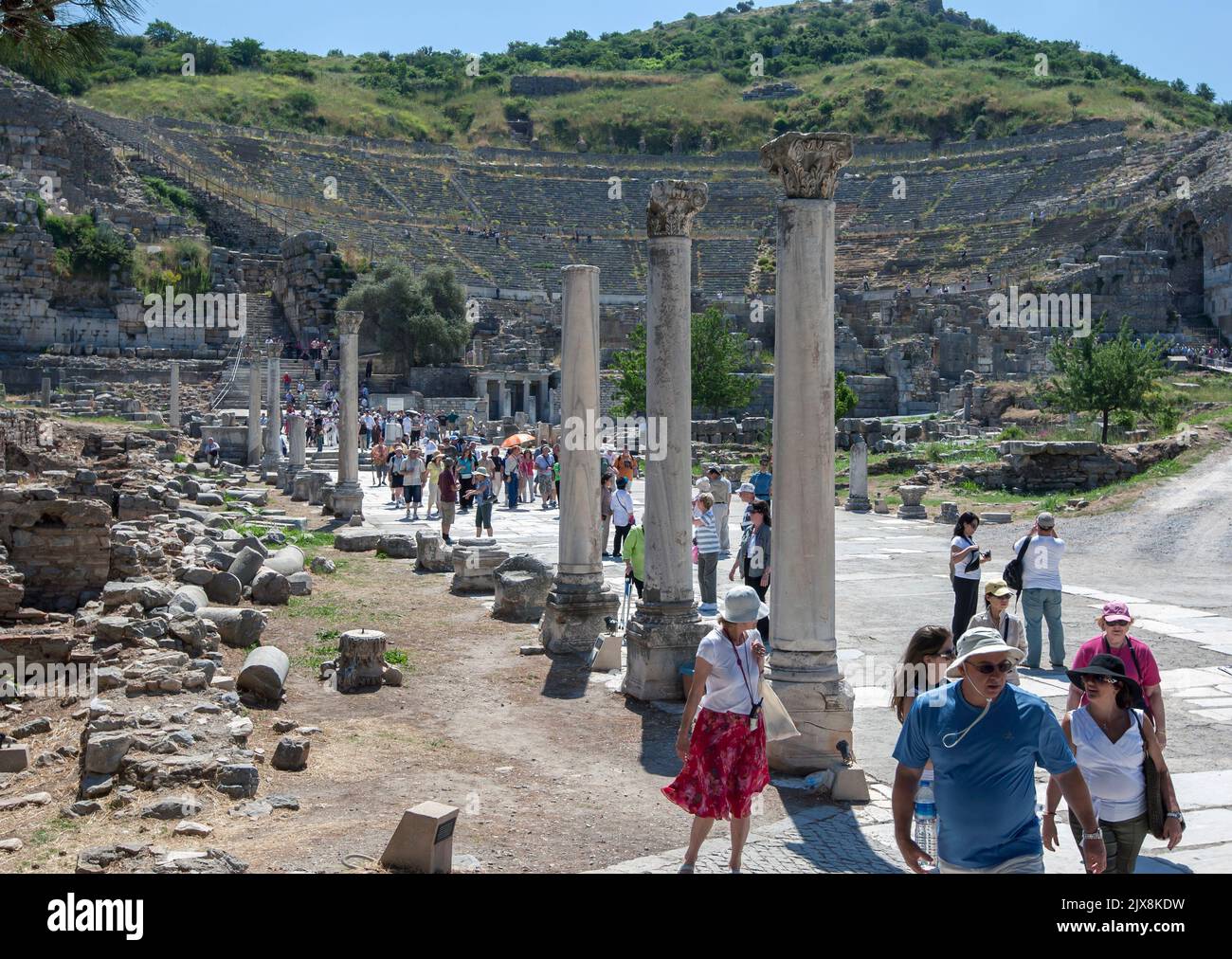 Tourists walk along Harbour Street after visiting the Roman Theatre at the ancient city of Ephesus in Turkey. Stock Photo