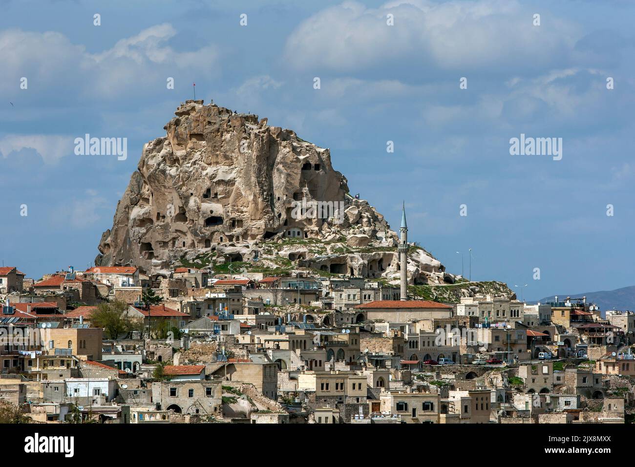 The volcanic rock outcrop known as Uchisar Castle at Uchisar in the Cappadocia region of Turkey. It has ancient tunnels and stairways. Stock Photo
