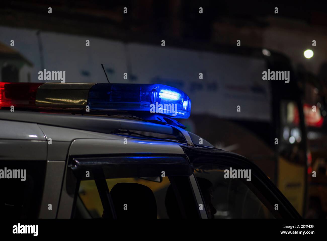 Emergency light of police patrolling car on street in night Stock Photo