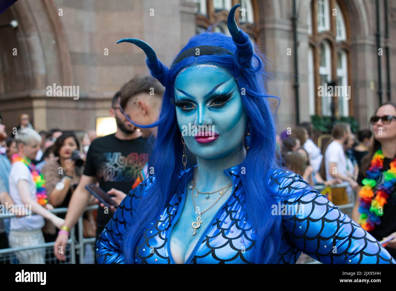 Manchester Pride parade. Woman in blue snake costume. Theme March for Peace. Stock Photo