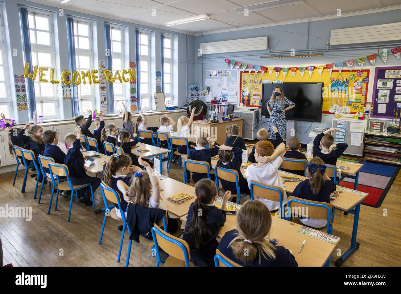 File photo dated 08/03/21 of a teacher with her class, as Liz Truss has been urged to tackle poor mental health in schools after a study showed hundreds of teachers were missing lessons to give students 'urgent medical attention'. Stock Photo