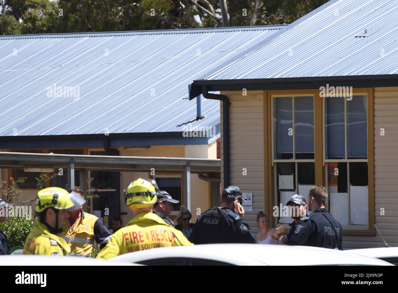 Police and paramedics are seen at a scene of a car crash in Greenacre, Sydney on Tuesday