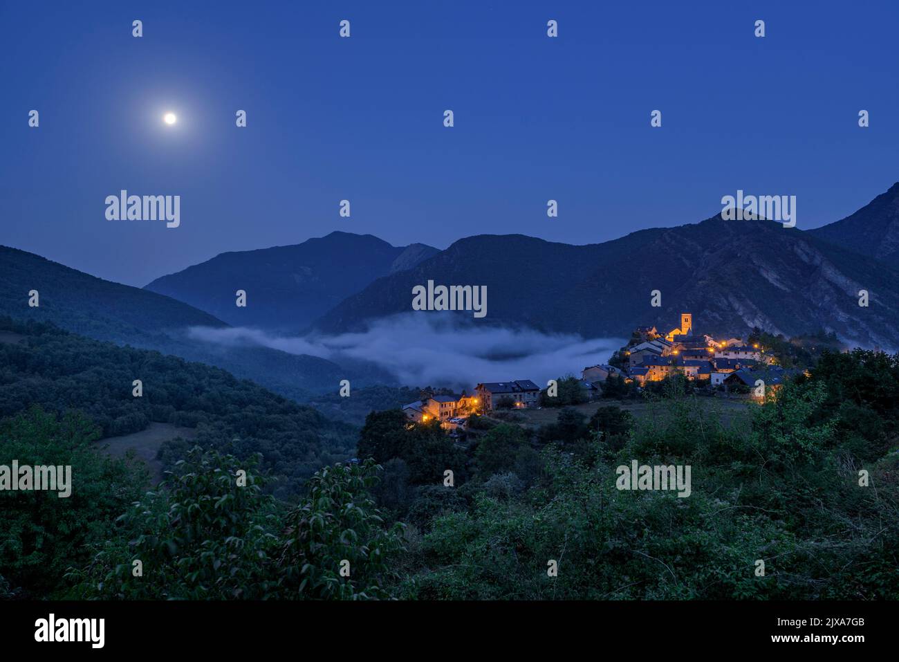 Tírvia village at blue hour with fog (Pallars Sobirà, Lleida, Catalonia, Spain, Pyrenees)  ESP: Pueblo de Tírvia en la hora azul con niebla (Lérida) Stock Photo