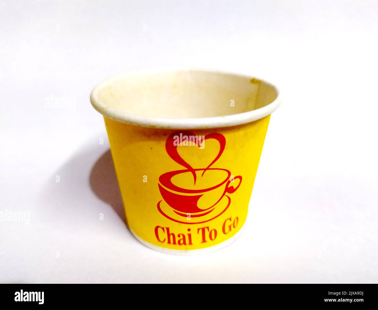 a yellow vecant paper tea cup put on isolated on white background Stock