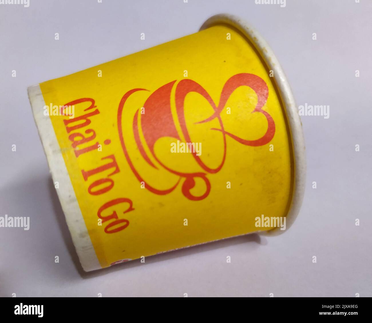 a yellow vecant paper tea cup put on isolated on white background Stock