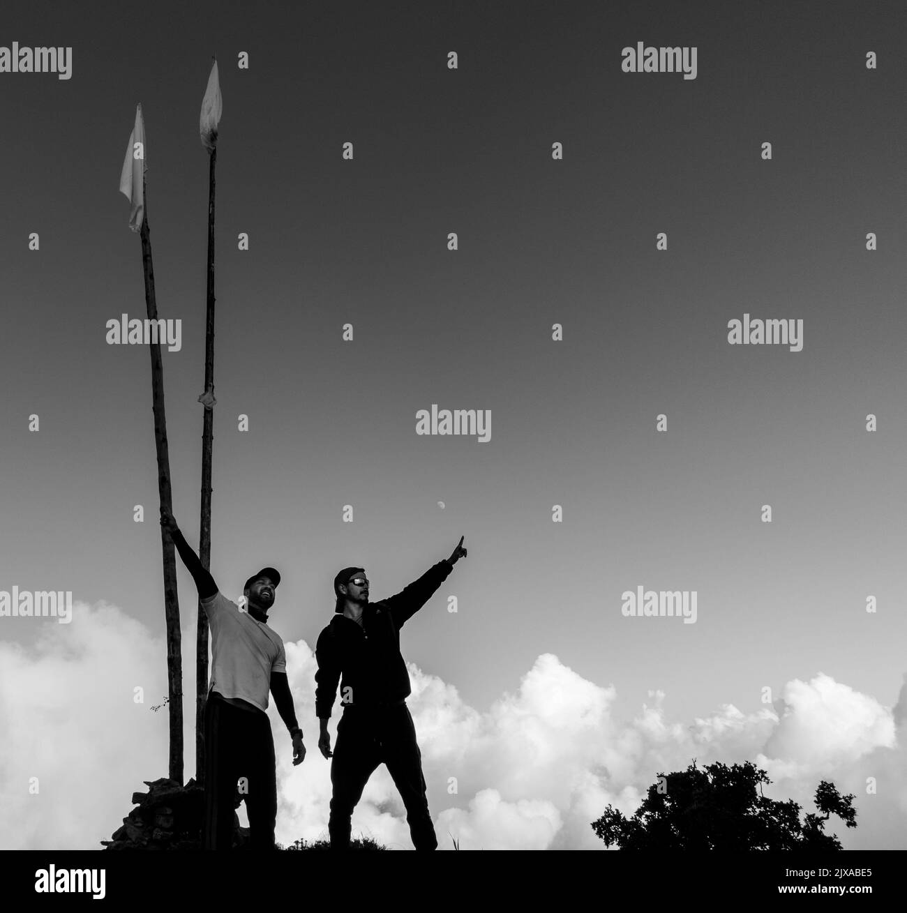 September 15th 2021, Nagtibba mountain Uttarakhand India. A monochromatic shot of hikers celebrating at the top of the mountain summit. Stock Photo