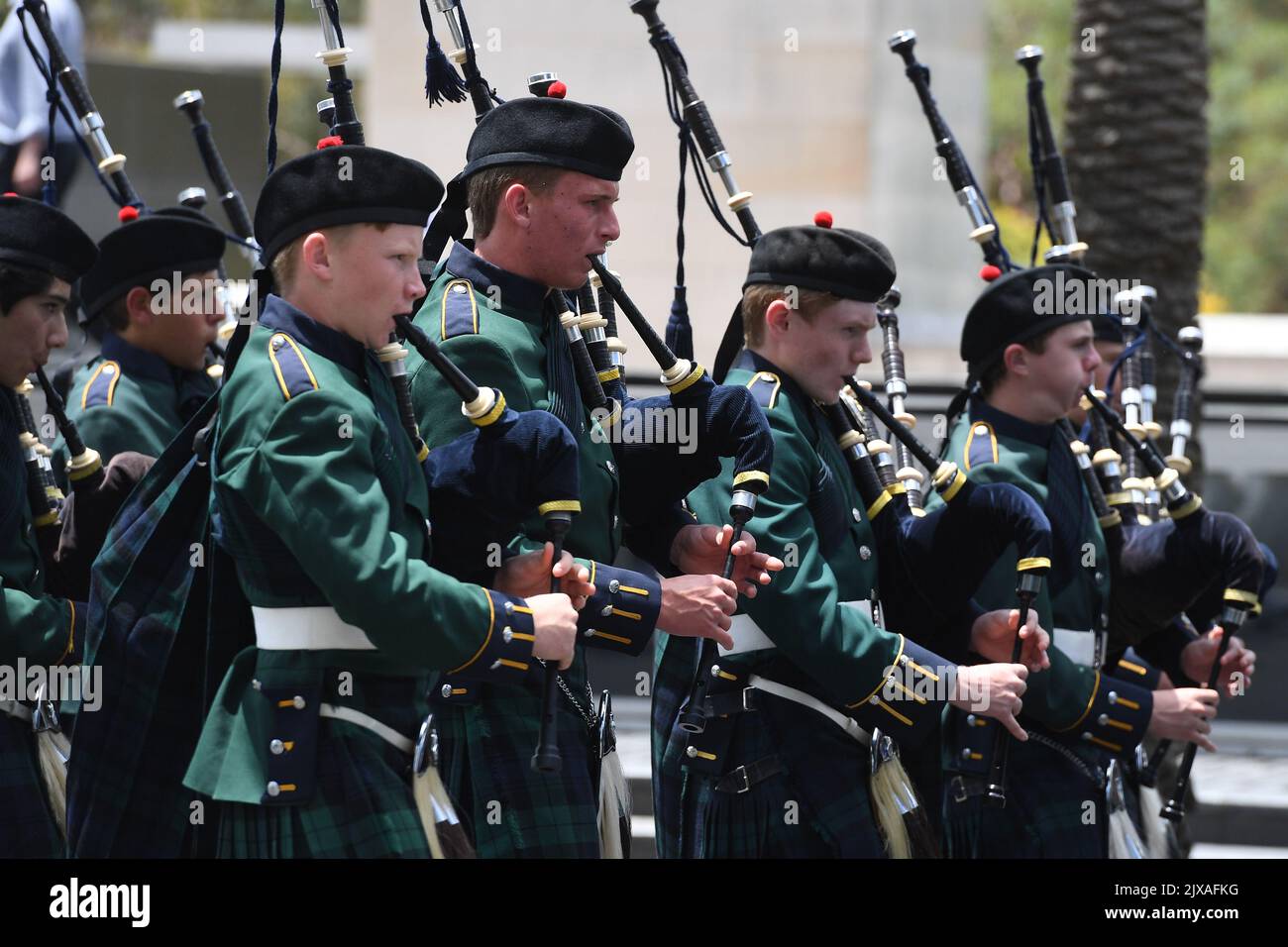 A Scottish bagpipe band lead the hearse carrying the casket of AC/DC co ...