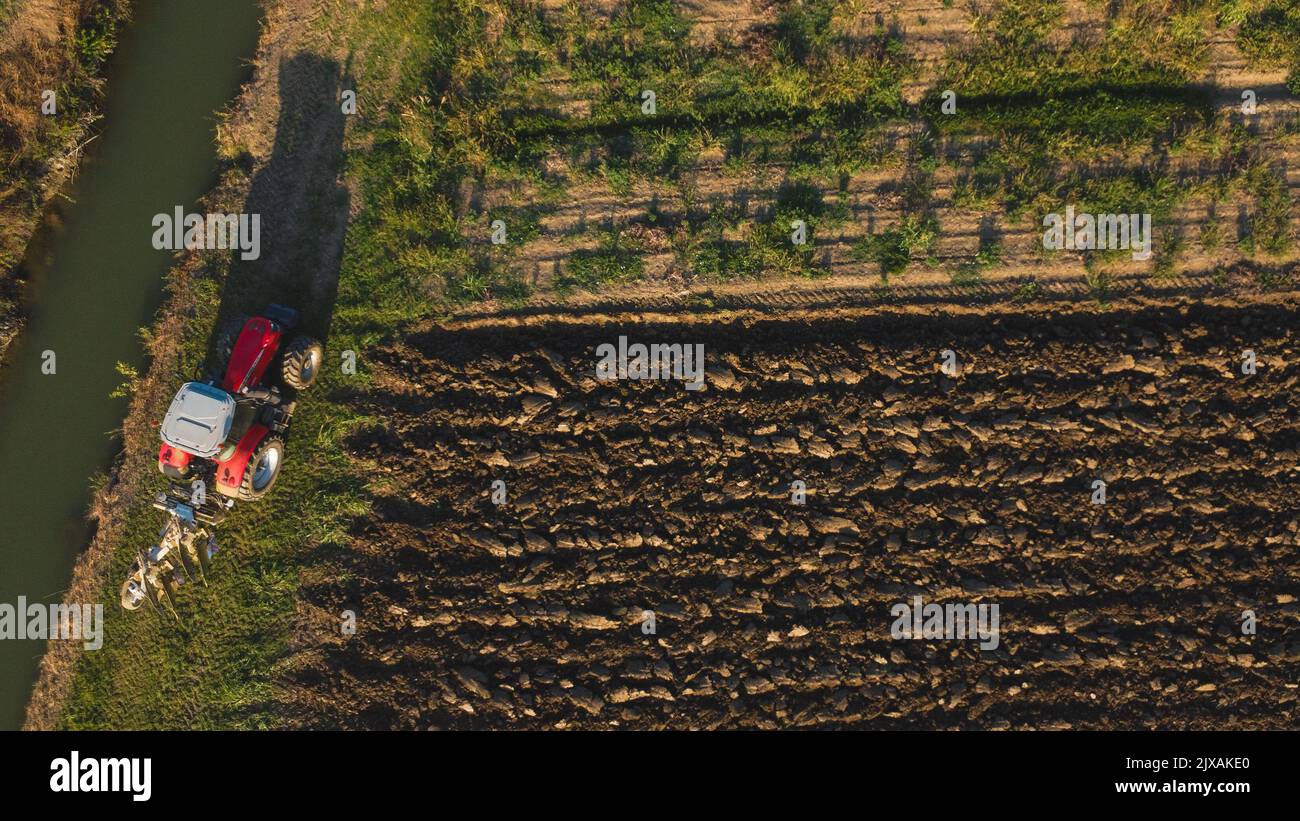 Aerial view with drone of tractor plowing the land in the countryside ...
