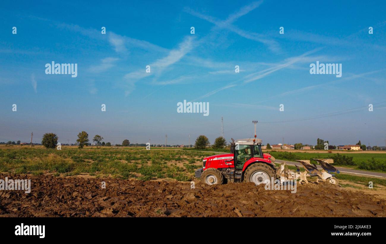 Aerial view with drone of tractor plowing the land in the countryside ...