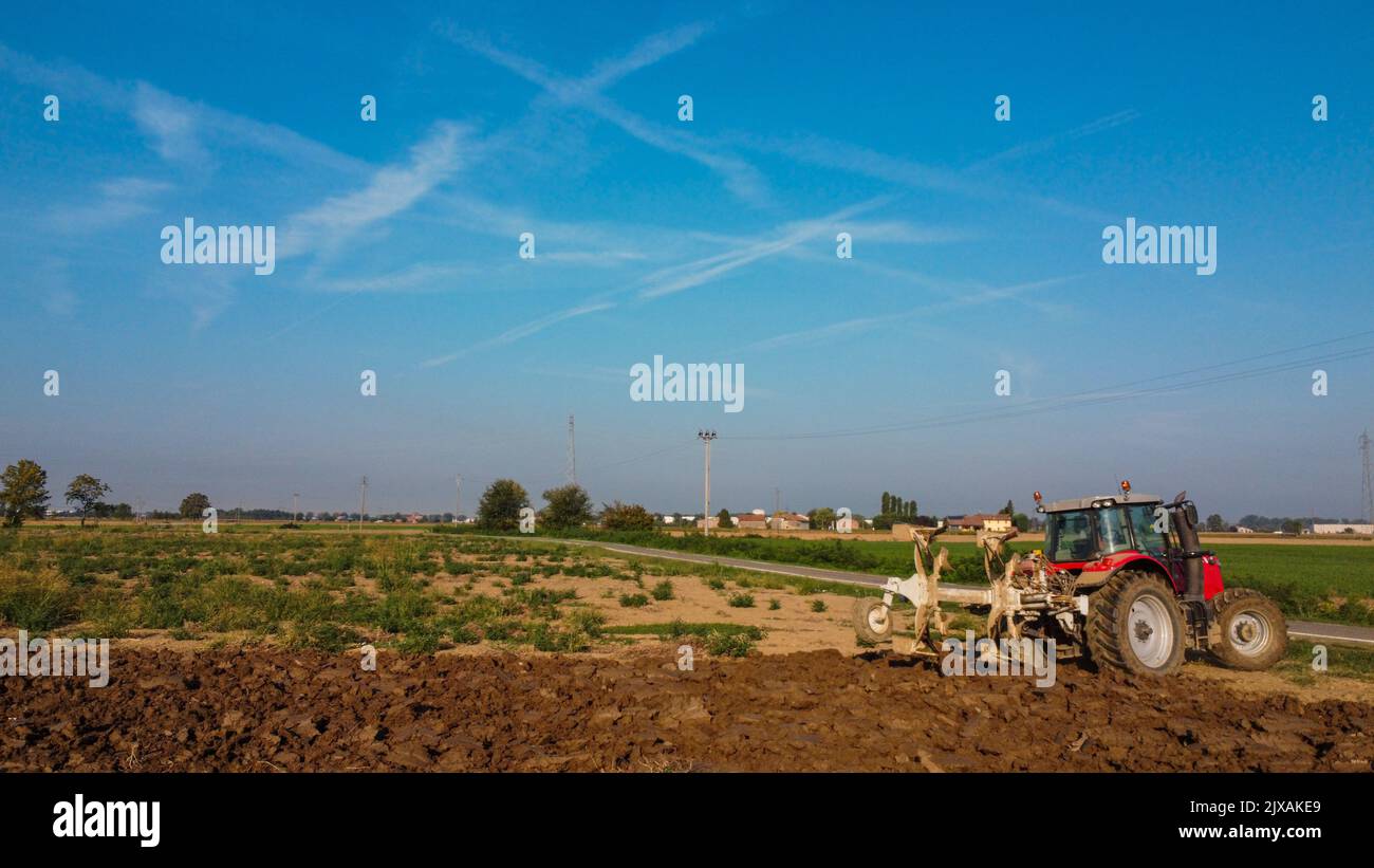 Aerial view with drone of tractor plowing the land in the countryside ...