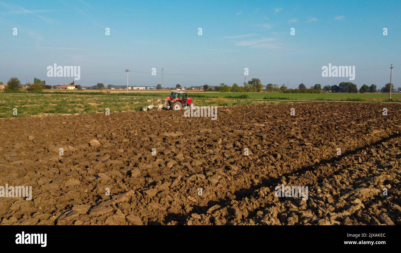 Aerial view with drone of tractor plowing the land in the countryside ...