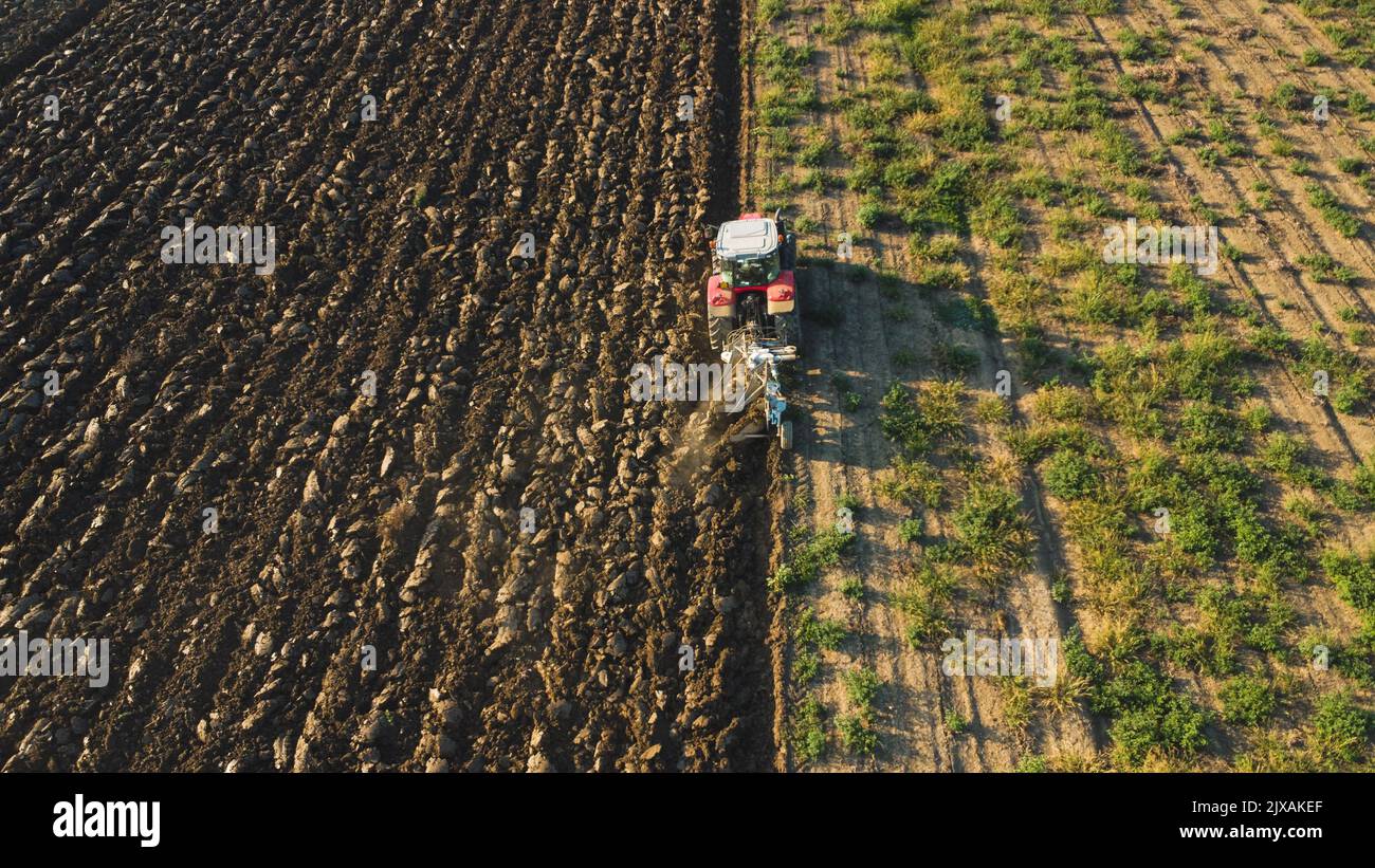 Aerial view with drone of tractor plowing the land in the countryside ...