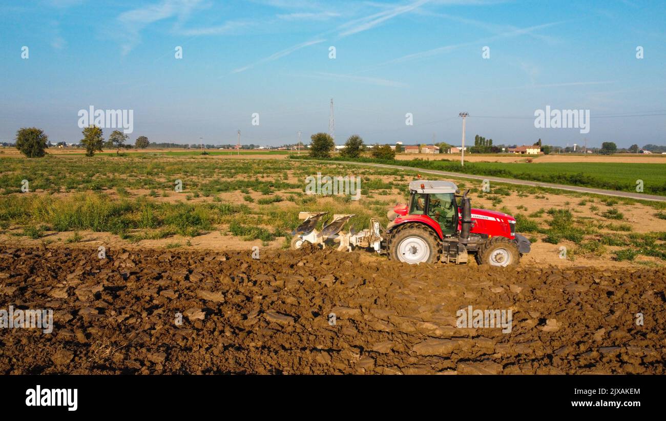 Aerial view with drone of tractor plowing the land in the countryside ...