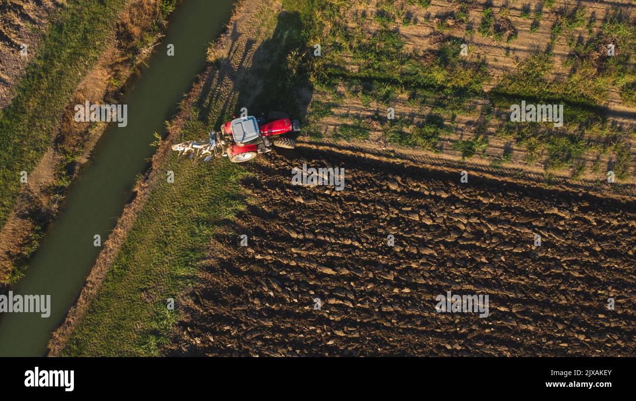Aerial view with drone of tractor plowing the land in the countryside ...