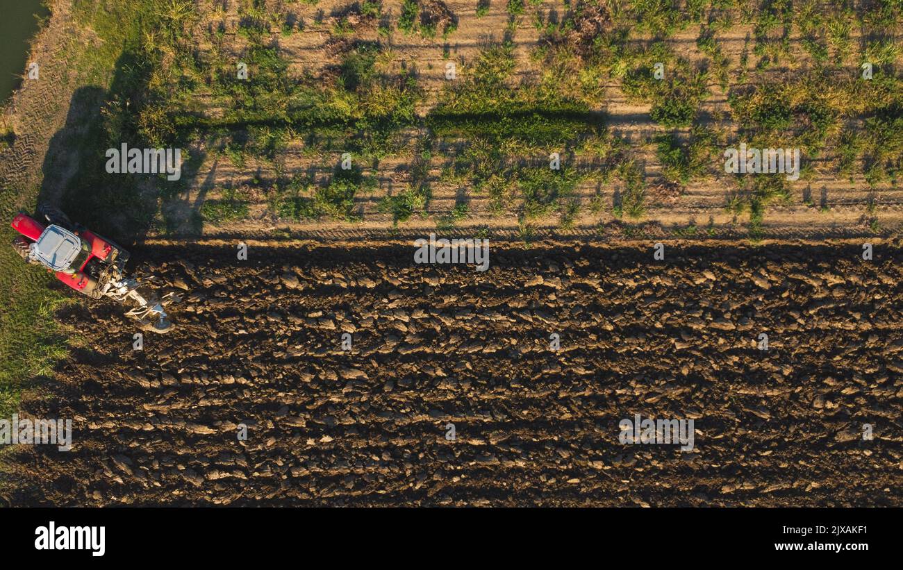 Aerial view with drone of tractor plowing the land in the countryside ...