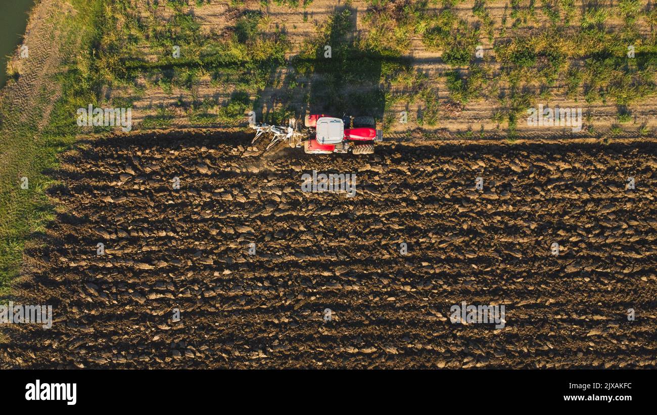 Aerial view with drone of tractor plowing the land in the countryside ...