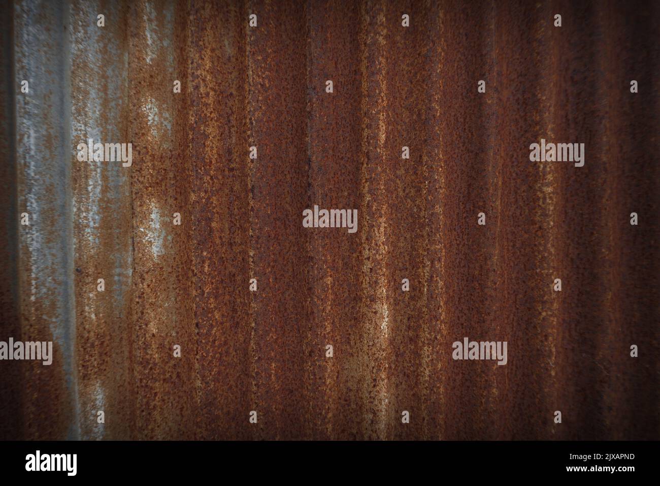 The texture of an old and rusted steel plate is used as a design background Stock Photo