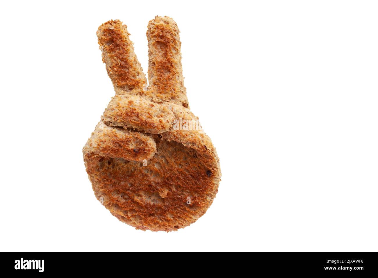 Hand peace sign made from toasted brown bread slice isolated on white background. Fun food concept and symbol Stock Photo