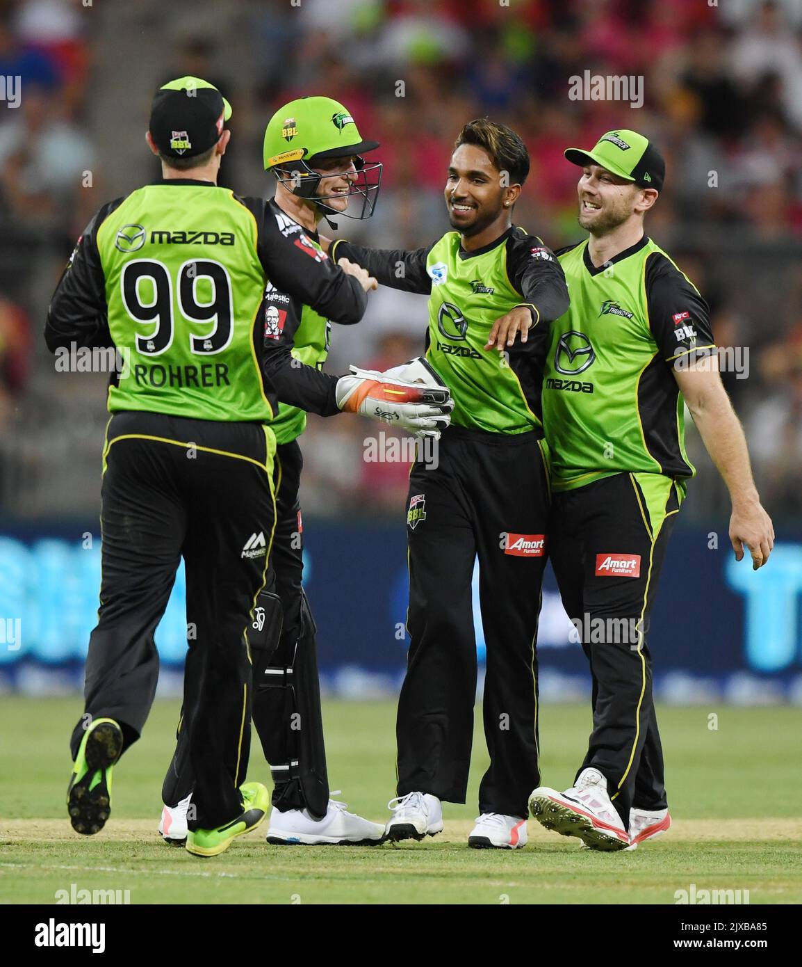 Arjun Nair of the Thunder (2nd right) celebrates with his team mates after  Shane Watson caught out Moises Henriques of the Sixers from one of his  deliveries during the Big Bash League (
