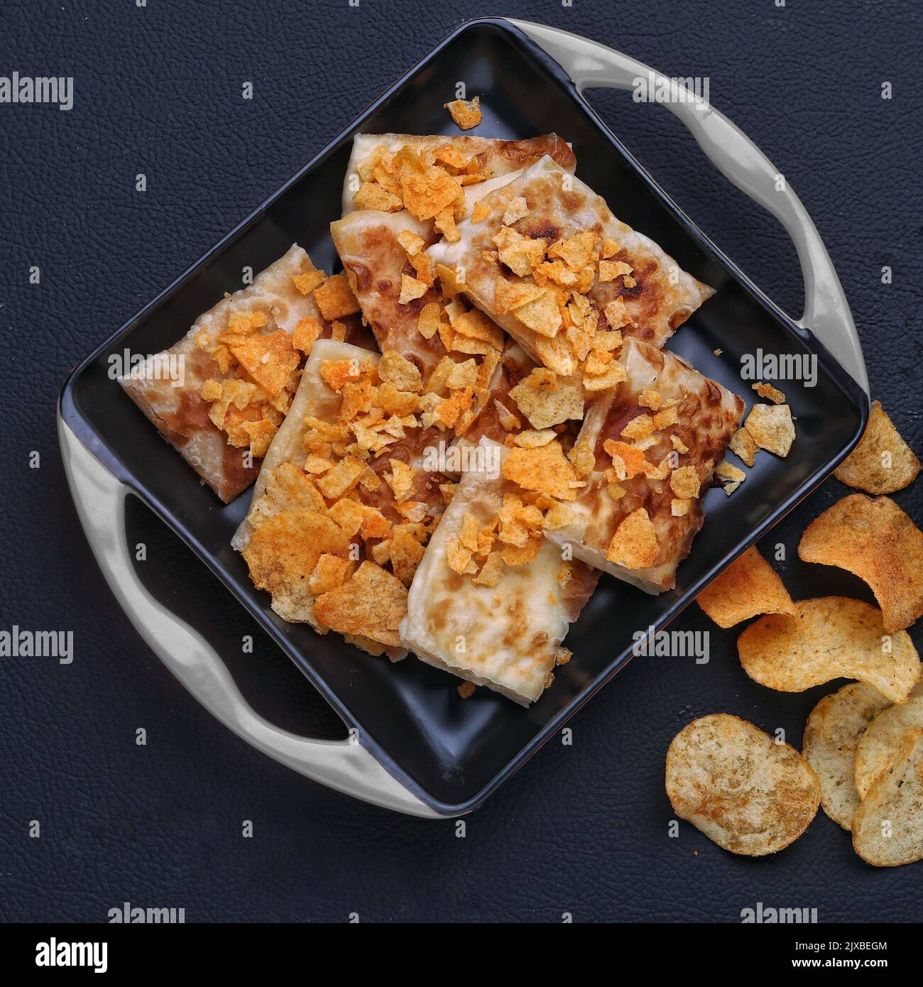 roasted tandoori roti with snacks arrange in a dish dark background studio photography Stock Photo