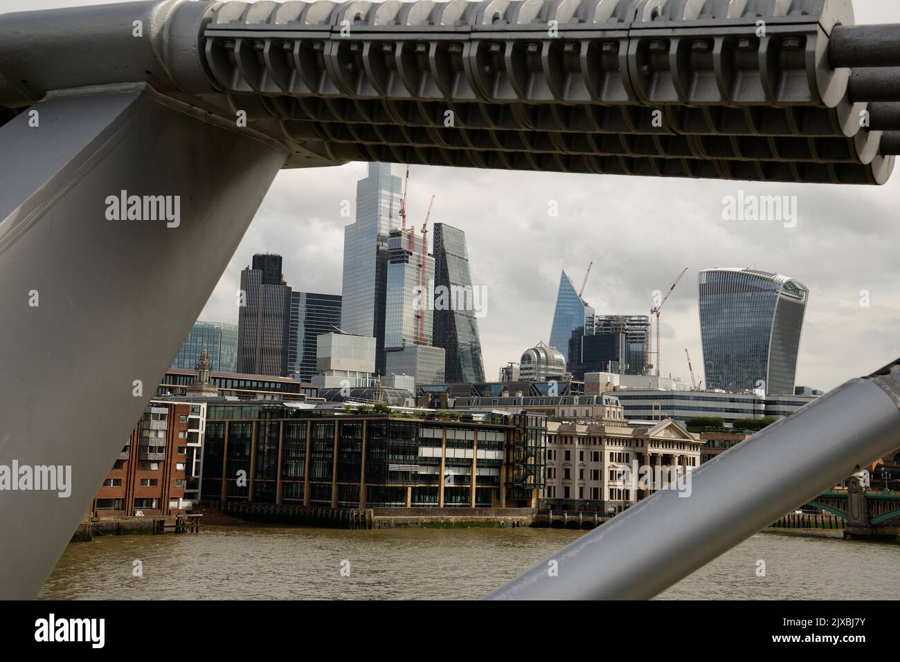 The City of London from the Millennium Bridge. The struts of the bridge framing the view of the City. Stock Photo