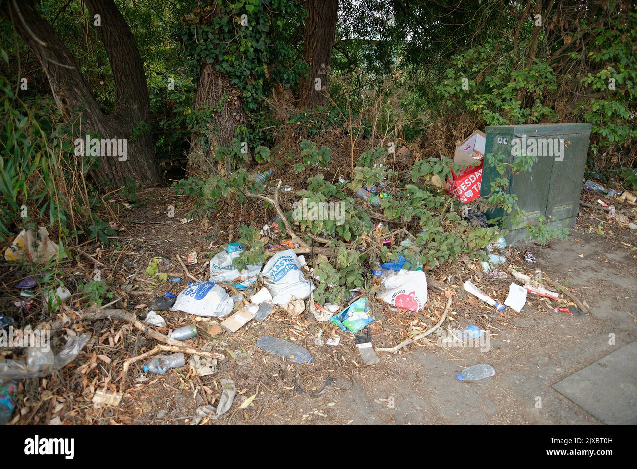 Rubbish or trash at the side of a road in London, England. An unattractive sight. An unhealthy environment. Stock Photo