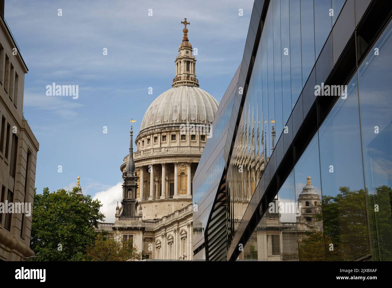 St Pauls cathedral, London designed by Sir Christopher Wren and its reflection in a modern glass clad office building. Stock Photo