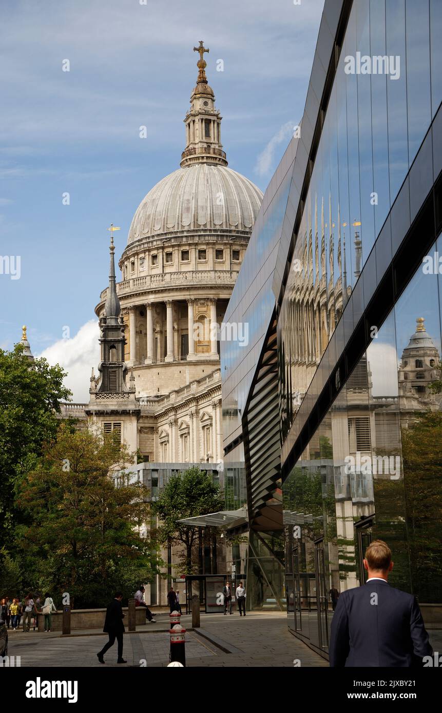 St Pauls cathedral, London designed by Sir Christopher Wren and its reflection in a modern glass clad office building. Stock Photo