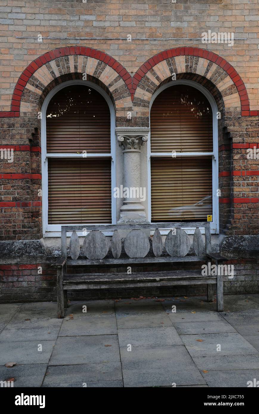 Ornate wooden seat and brickwork arches, Brewery Square, Dorchester, Dorset, UK Stock Photo