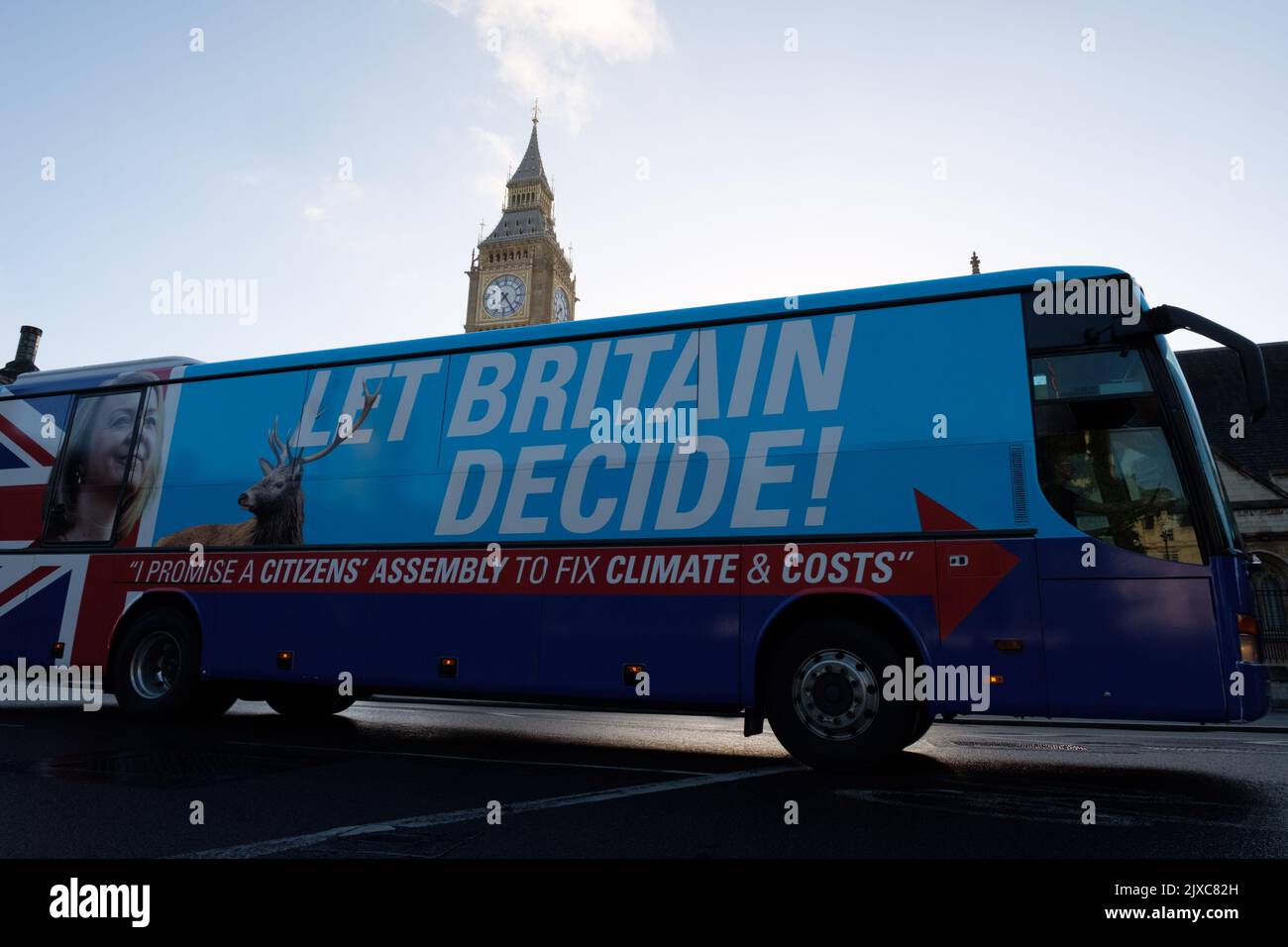 London, UK. 7 SEP, 2022.  A bus with Liz Truss face and a sign that reads “Let Britain Decide” and “I promise a citizens’ assembly to fix climate & costs” drives past the Houses of Parliament and around parliament square the morning that Britain wakes up with Liz Truss as first Prime Minister’s Questions after she was announced as the new Conservative party leader, and appointed as Prime Minister, replacing Boris Johnson. Credit: Joao Daniel Pereira Credit: Joao Daniel Pereira/Alamy Live News Stock Photo