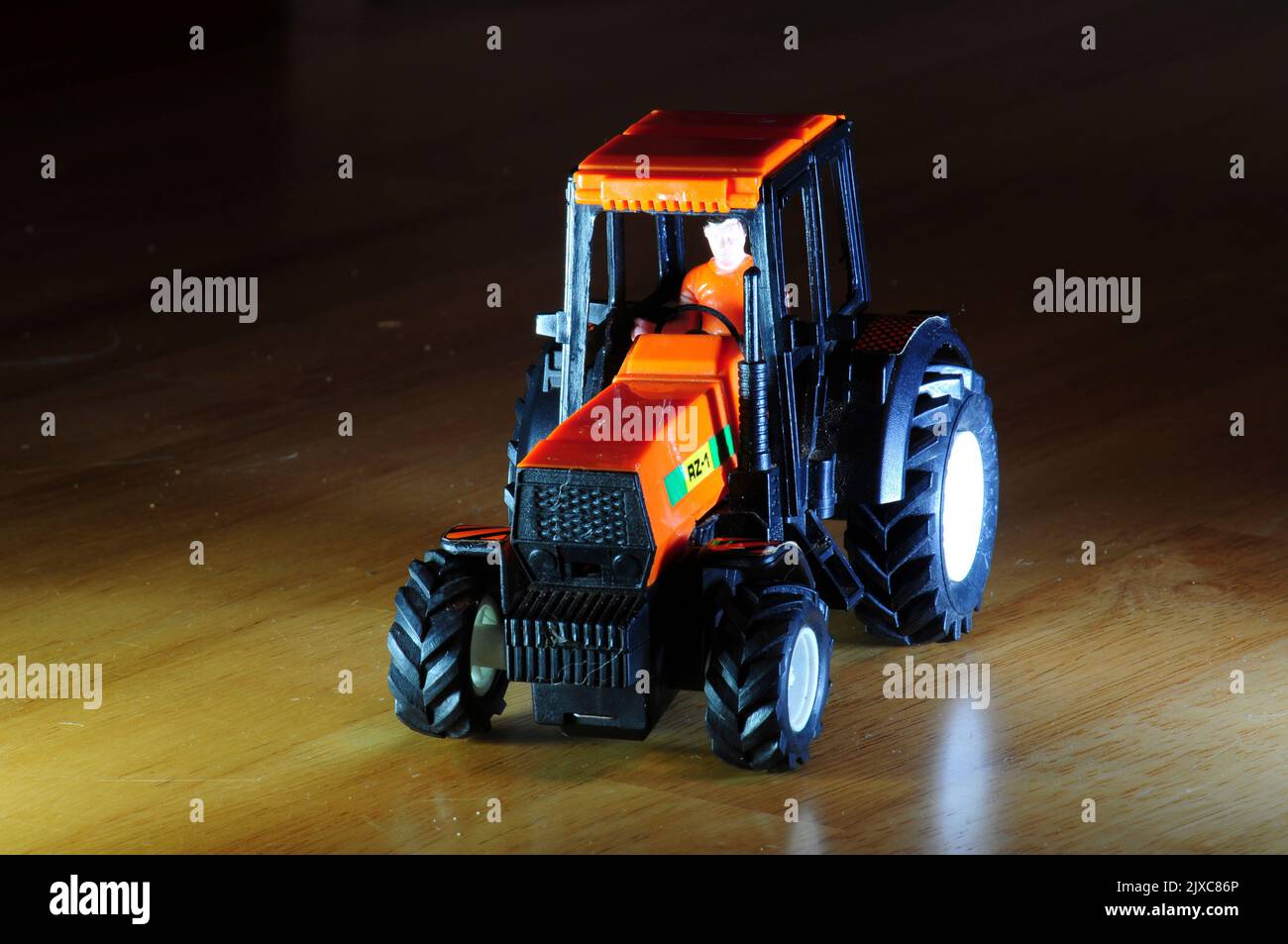 Toy tractor with driver inside Stock Photo