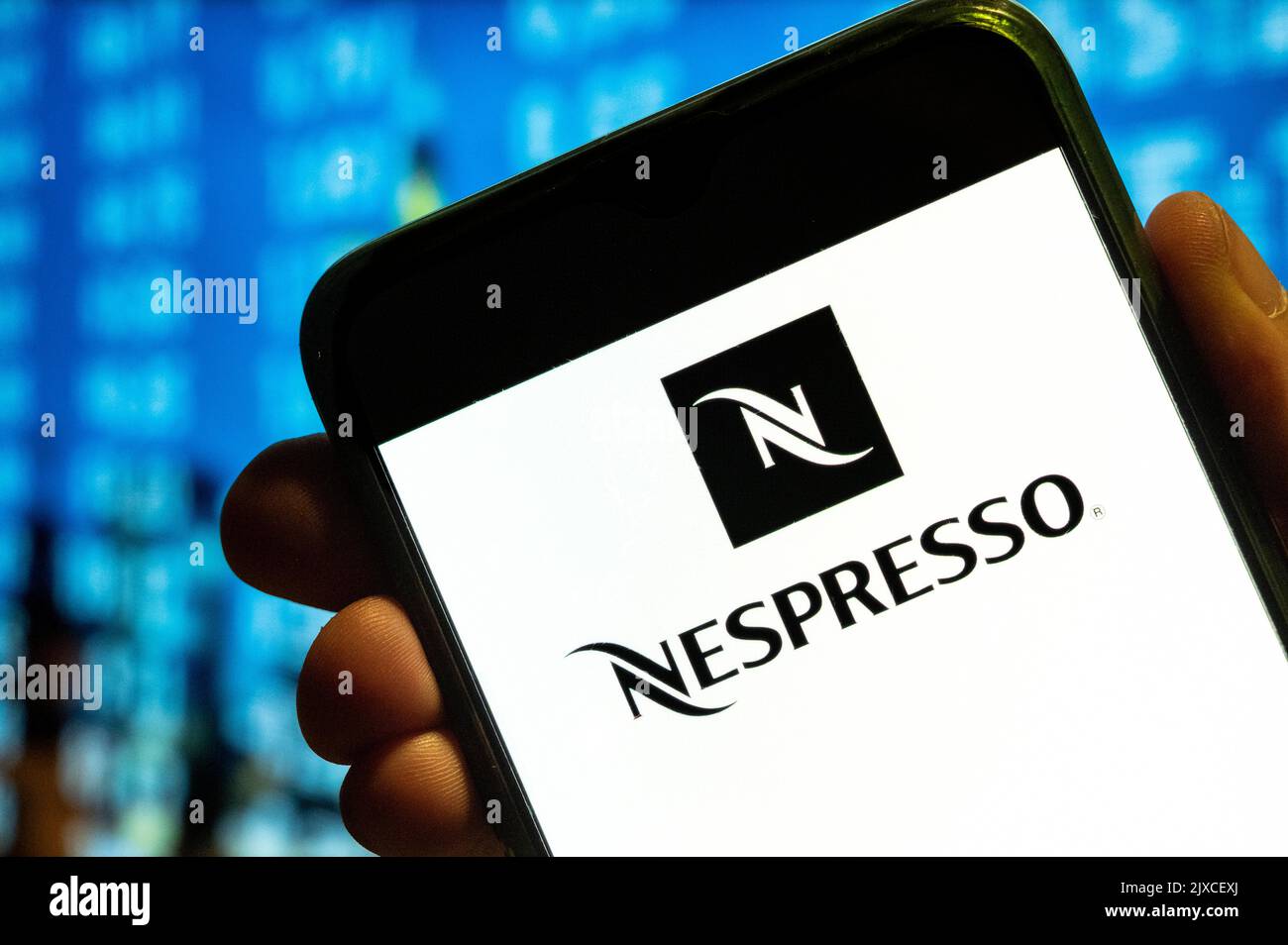 In this photo illustration, the Swiss high-end and world leader in coffee capsules brand store Nespresso logo is displayed on a smartphone screen. Stock Photo
