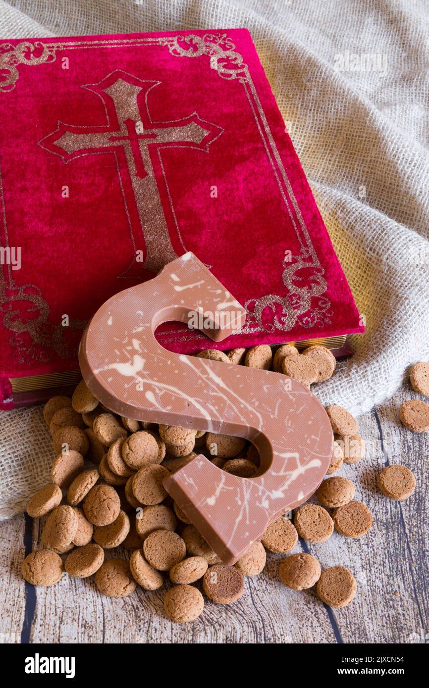 Dutch Sinterklaas tradition: A chocolate letter, the bookof Sinterklaas , a bag and candy called Pepernoten. Stock Photo