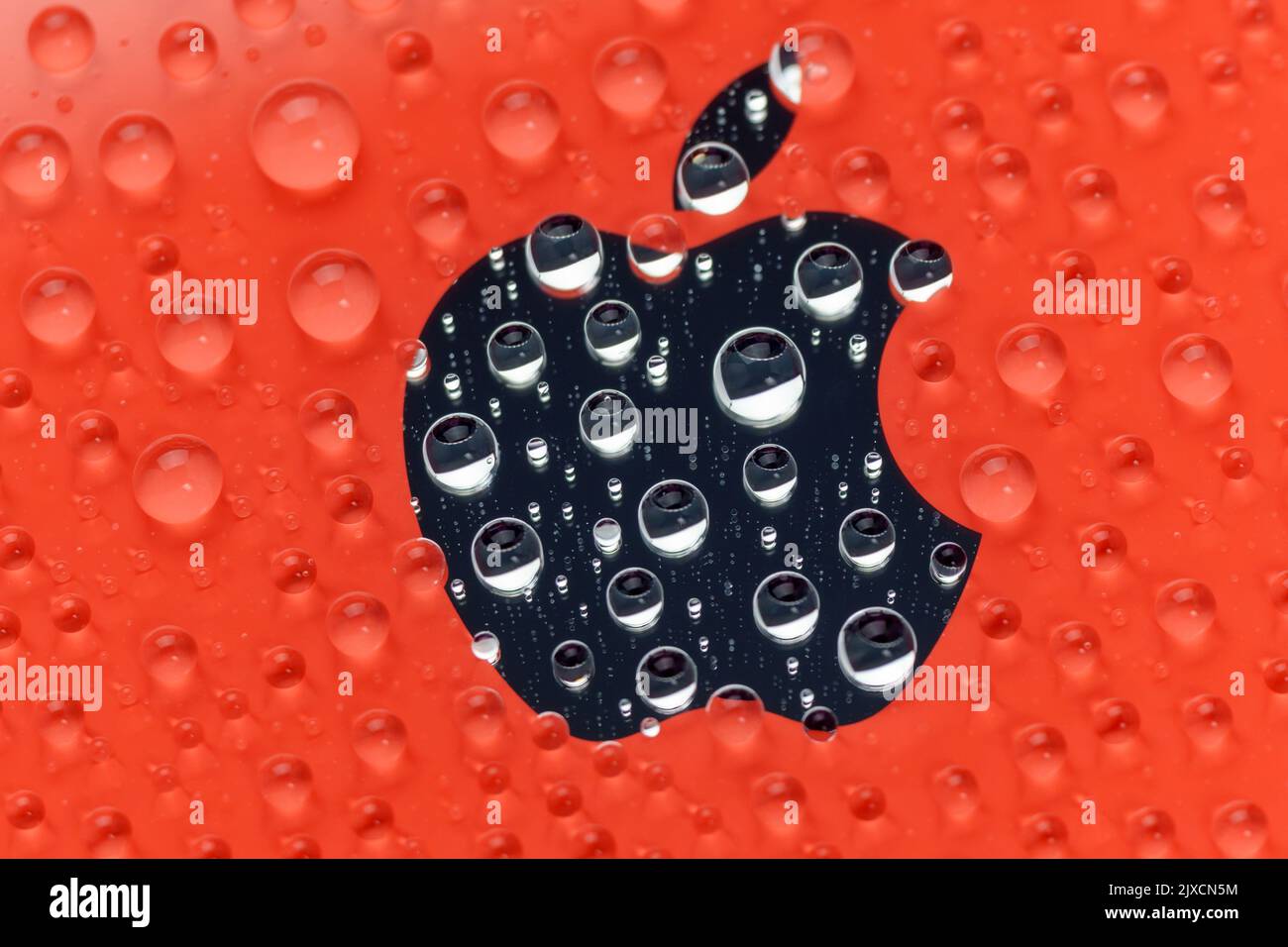 Tyumen, Russia-July 19, 2022: iPhone 12 mini Product red logo close up  macro, water drops. Selective focus Stock Photo - Alamy