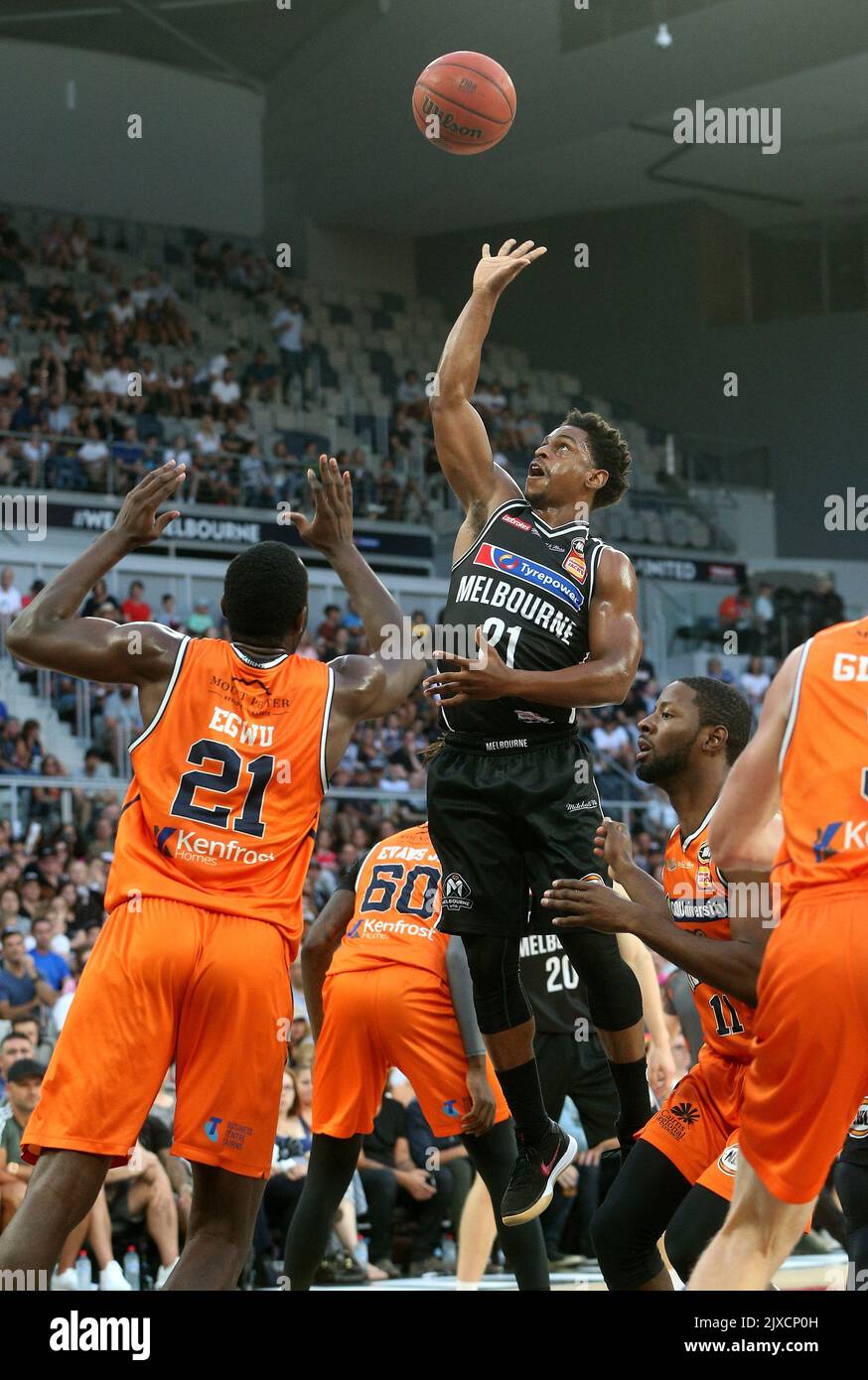 Casper Ware of Melbourne shoots over Nnanna Egwu of Cairns during the Round  16 NBL game