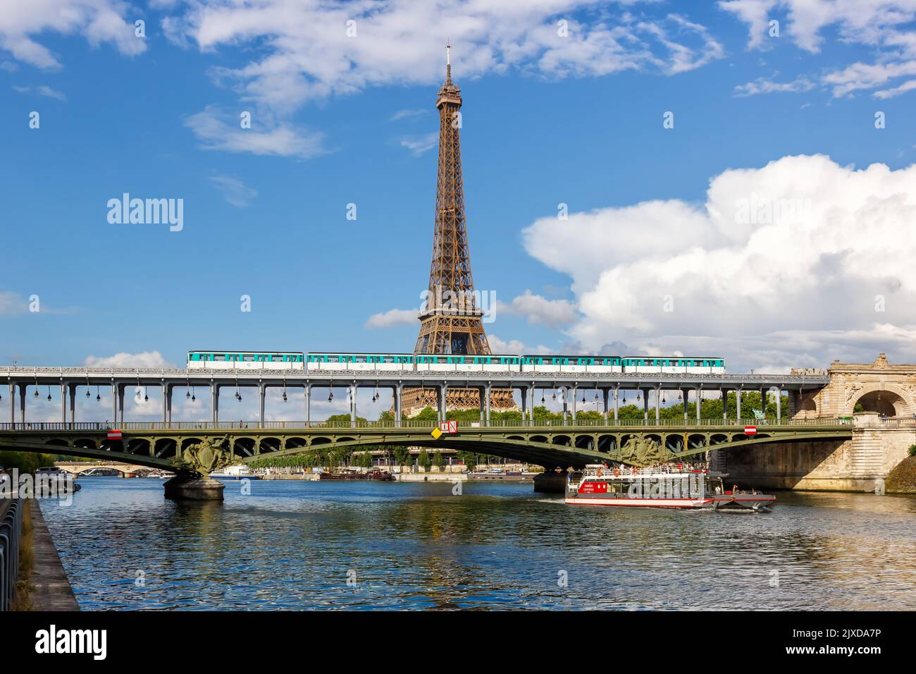Paris, France - June 5, 2022: Metro Paris over Seine river with Eiffel tower between stations Bir-Hakeim and Passy public transport in Paris, France. Stock Photo