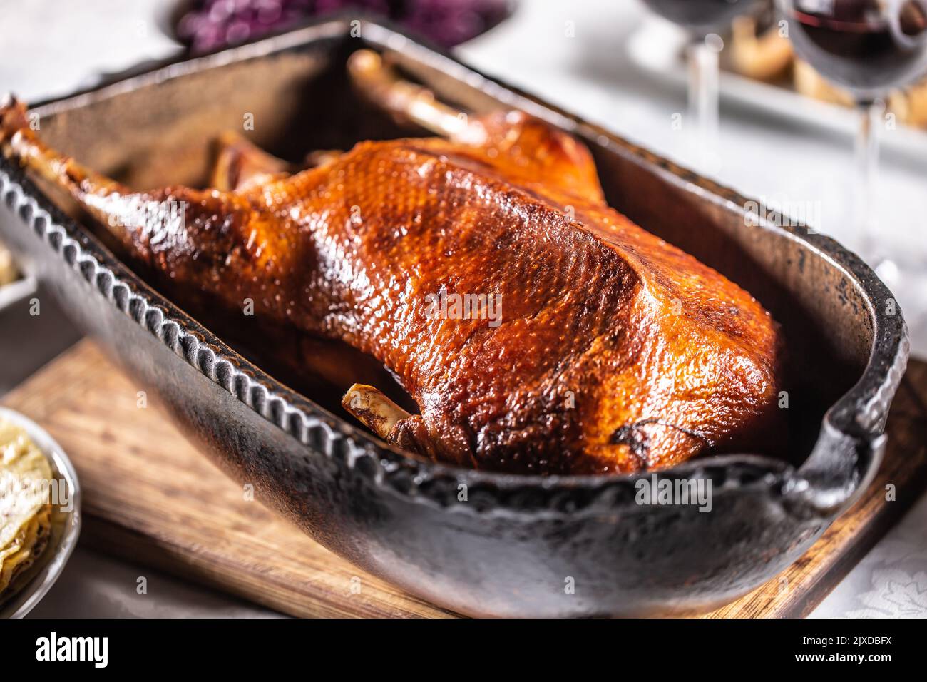 Traditionally roasted goose in an original baking dish - Close up. Stock Photo