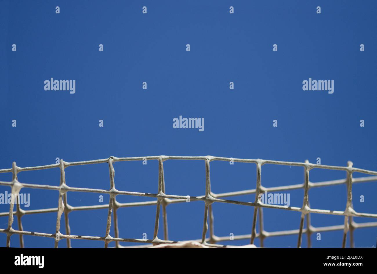 Detail of an old metal grid with sky to sky leaving copy space above for your texts Stock Photo